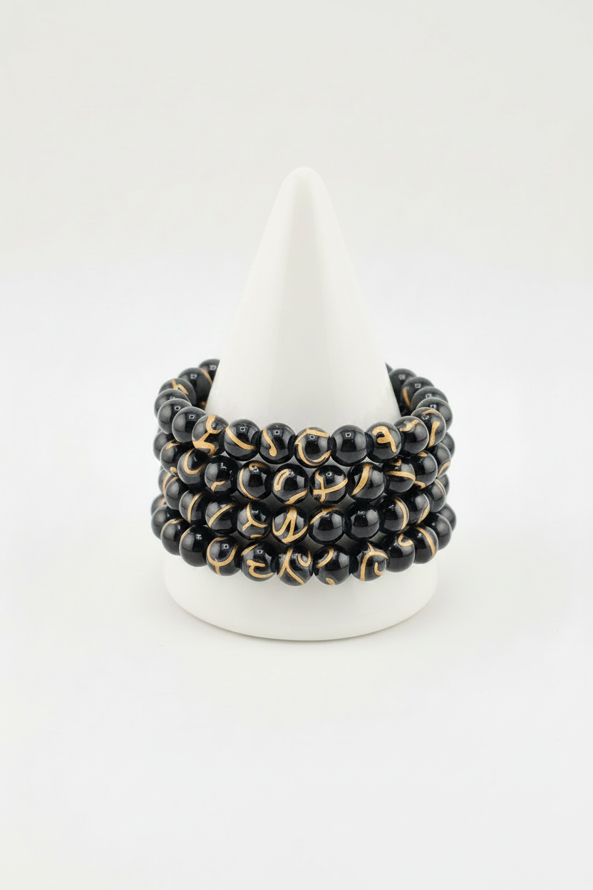 Black gold drawbench bracelet on white cone stand zoomed in