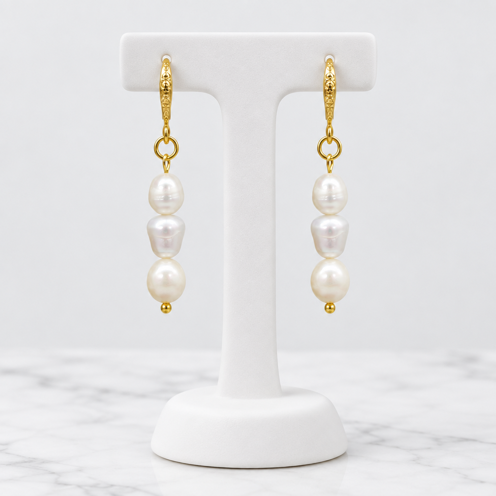 LDJ-0990 oval freshwater pearl earrings on a white porcelain display and marble background