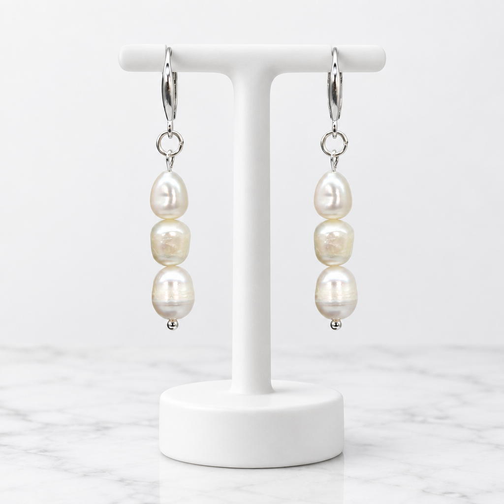 LDJ-0991 round freshwater pearl earrings on a white porcelain display and marble background