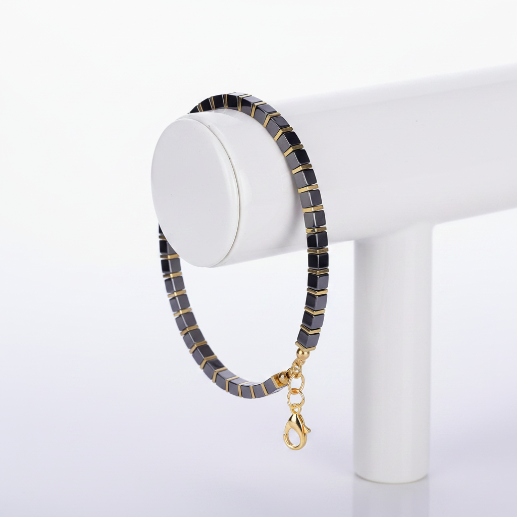 Black Gold Tila Bracelet on White Ceramic Stand