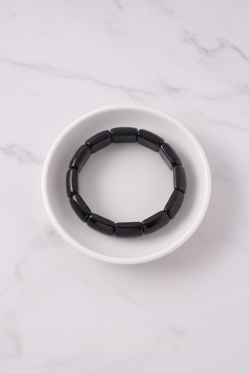 Black rectangular bead bracelet flat lay