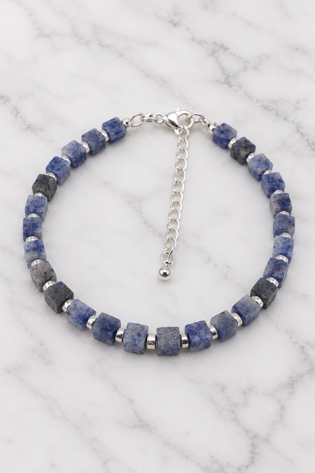 Blue cube bead bracelet flat lay on white marble