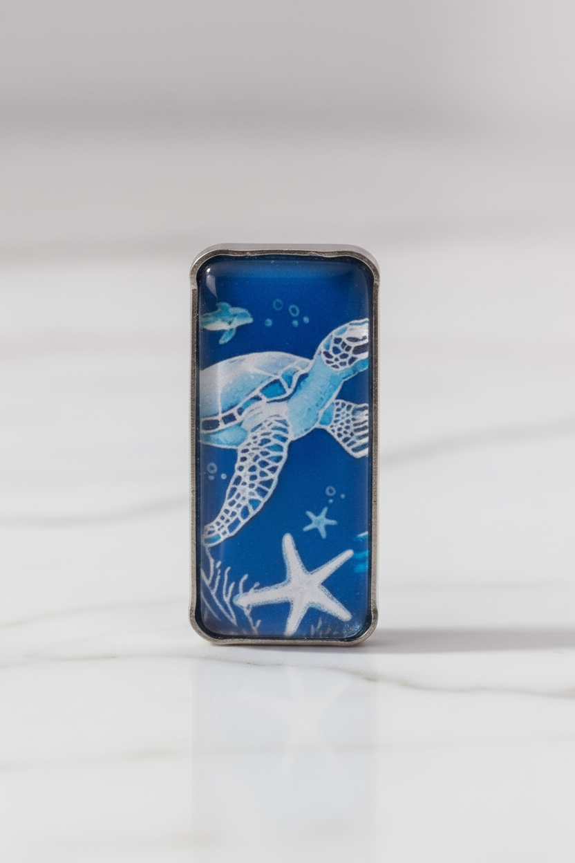 Extreme close-up of blue sea turtle earring pendant