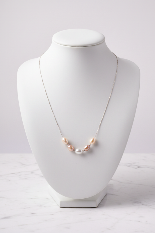 Five-pearl necklace on white porcelain bust