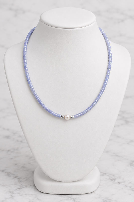 Lavender-blue shell bead necklace with pearl and silver spacers on white porcelain bust