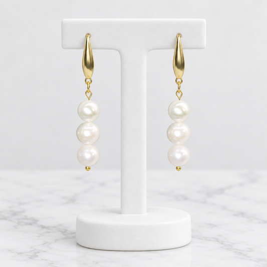 LDJ-0977 freshwater pearl gold-plated earrings on a white porcelain display and marble background