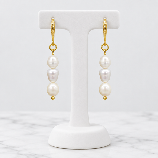 LDJ-0990 oval freshwater pearl earrings on a white porcelain display and marble background