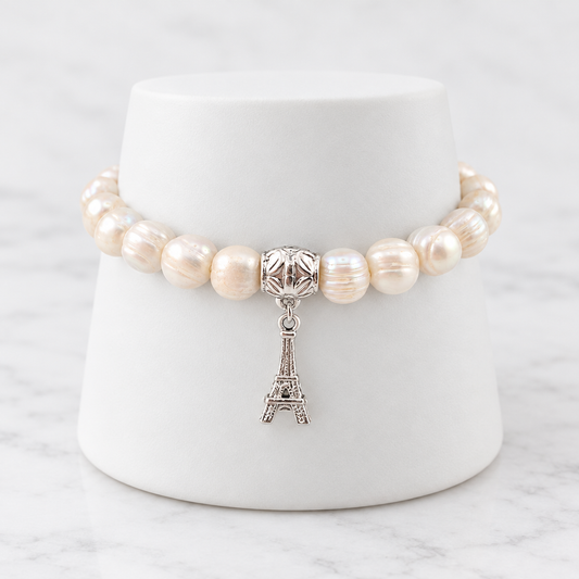 LDJ-1258 freshwater pearl bracelet with Eiffel Tower charm on white porcelain and marble
