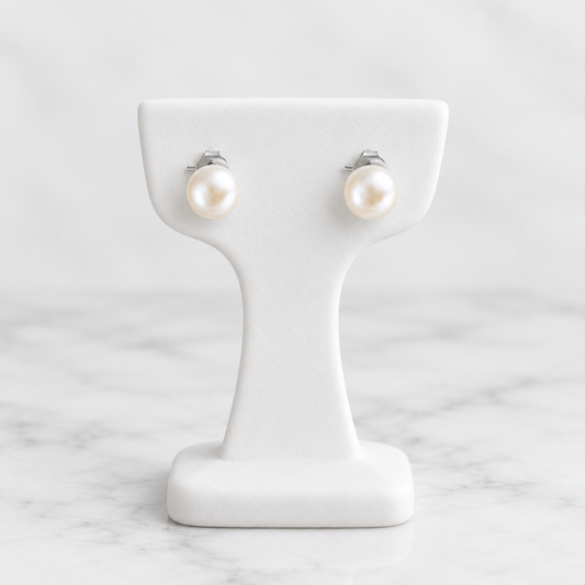 LDJ-1519 small freshwater pearl stud earrings on a white porcelain display and marble background