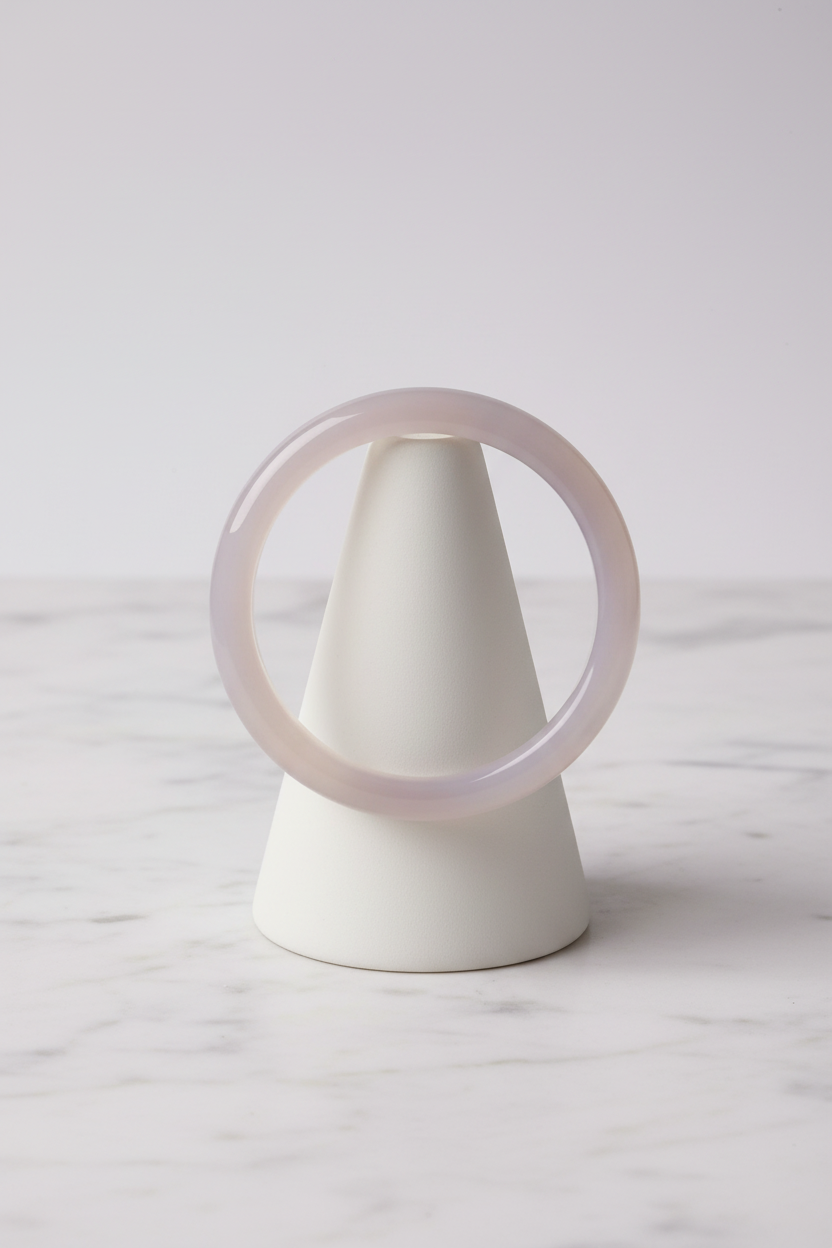 Translucent smoky-lilac bangle on white porcelain cone