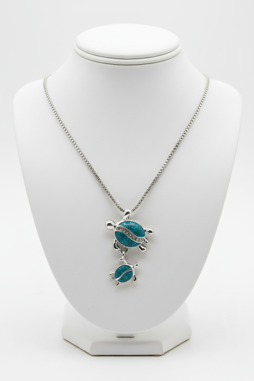 Turtle necklace on white porcelain bust stand
