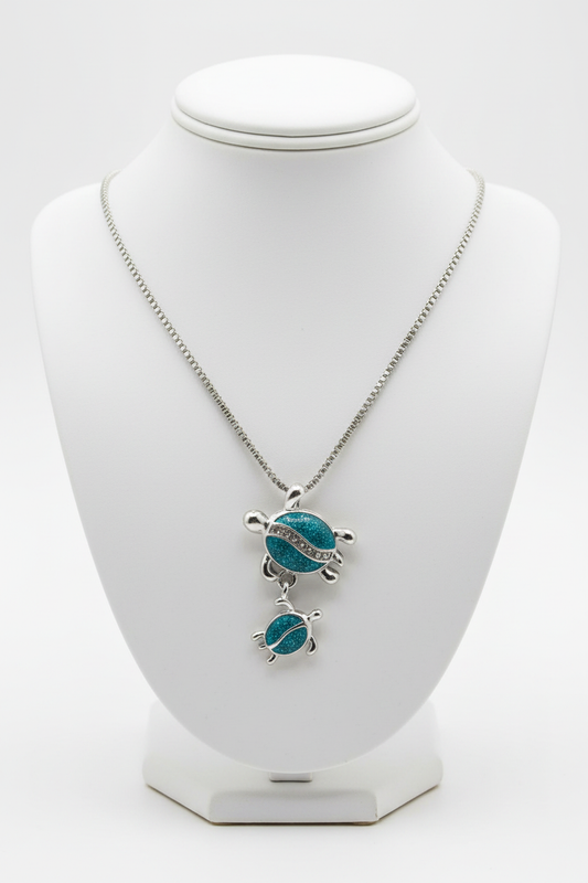 Turtle necklace on white porcelain bust stand